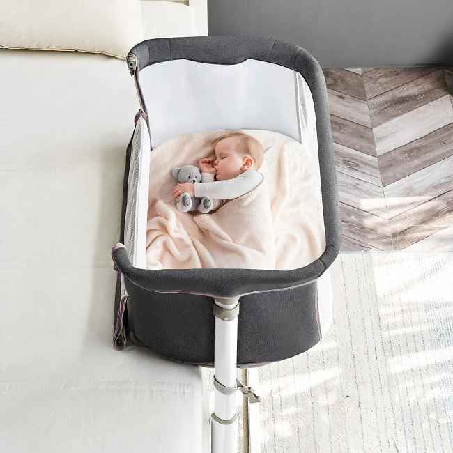 ​​Co-Sleeping Convenience:​​
Adjust this bedside crib to match your adult bed height (9 adjustable levels) for effortless nighttime feeding, comforting, and bonding.  Easily reach your baby without leaving your bed.

Secure & Stable Sleep:​​
A robust, rigid frame minimizes wobble, providing the steady foundation babies need for deeper, longer-lasting sleep.

Safety & Comfort Assured:​​
Built with certified, non-toxic materials and features a firm, supportive mattress wrapped in a soft, skin-friendly cover.

Seamless Parental Care:​​
The front side lowers for instant access, letting you comfort or attend to your baby quickly and maintain closeness while they rest securely in their own space.

Complete, Easy-Clean Setup:​​
Includes a quality mattress and a removable, washable cover for simple hygiene – ensuring a consistently clean, comfortable sleep environment.

Enduring Quality, Direct Value:​​
Benefit from factory-direct savings on a bedside crib built under strict quality-controlled processes by an experienced Chinese manufacturer known for durable infant products.